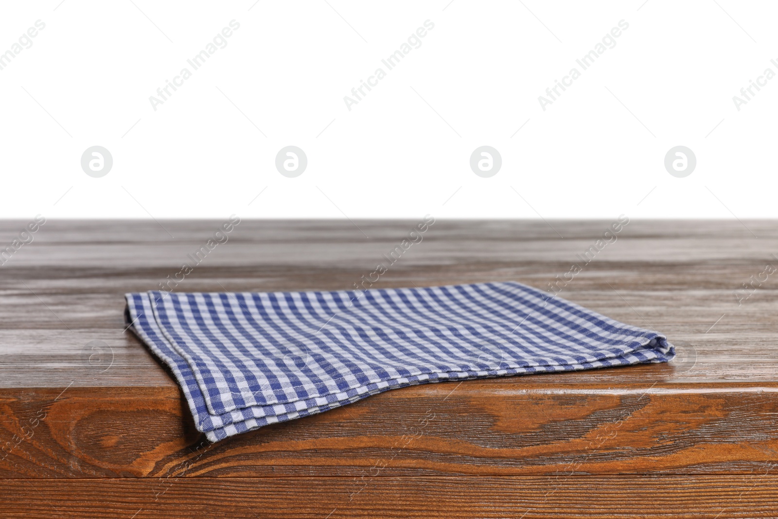 Photo of Checkered tablecloth on wooden table against white background