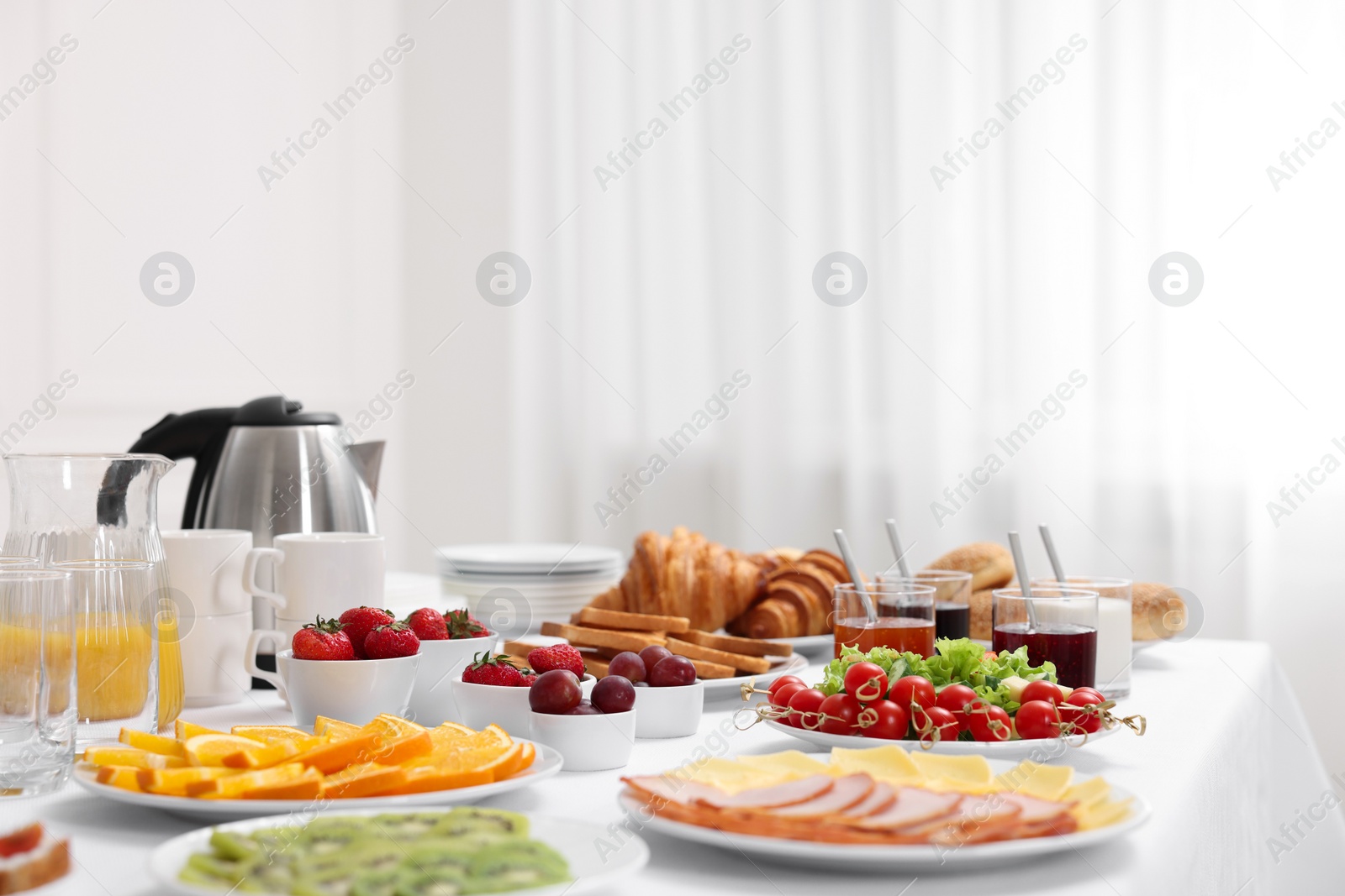 Photo of Different meals served on white table indoors. Buffet menu