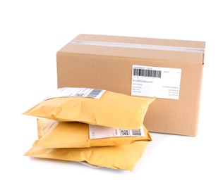 Photo of Padded envelopes and cardboard parcel on white background