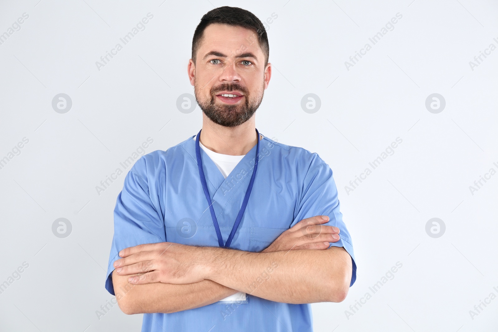 Photo of Portrait of mature doctor on white background