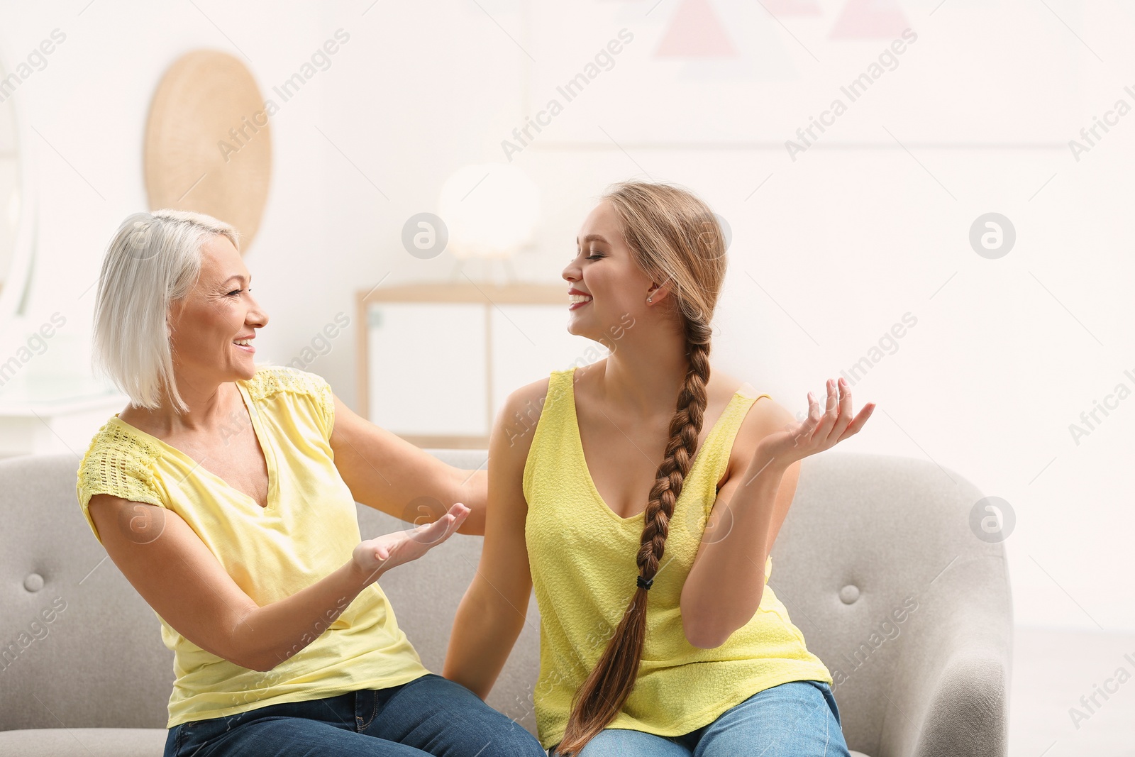 Photo of Mother and her adult daughter spending time together at home