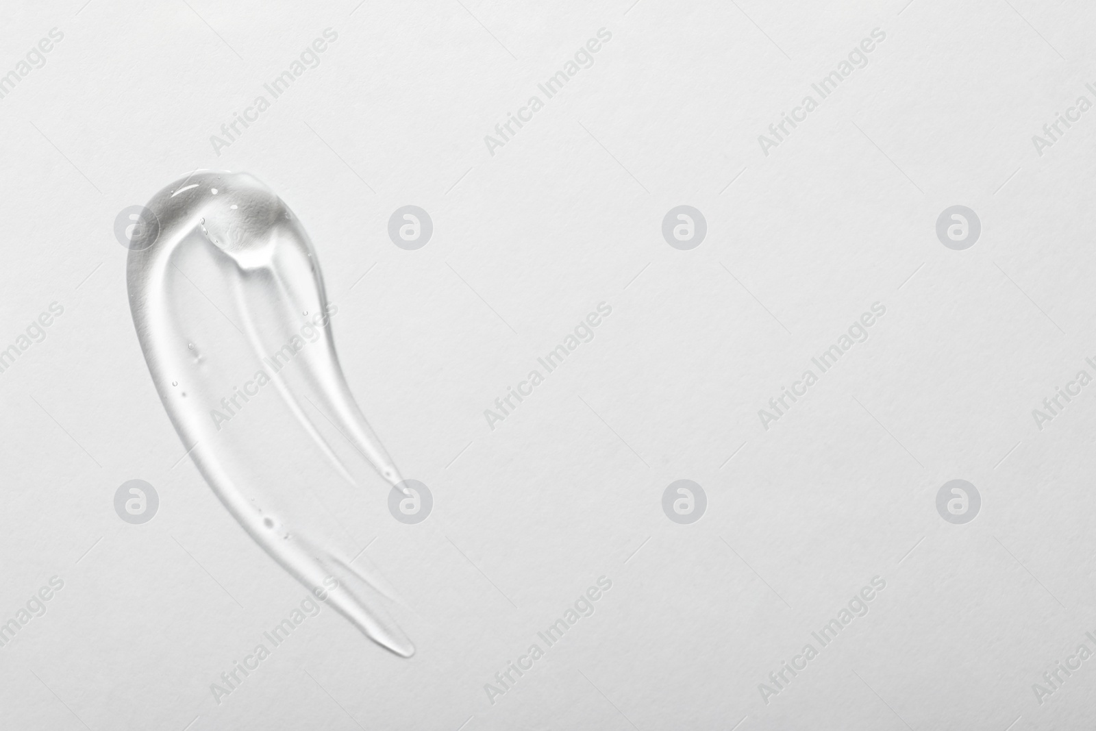 Photo of Sample of cosmetic gel on white background, top view. Space for text