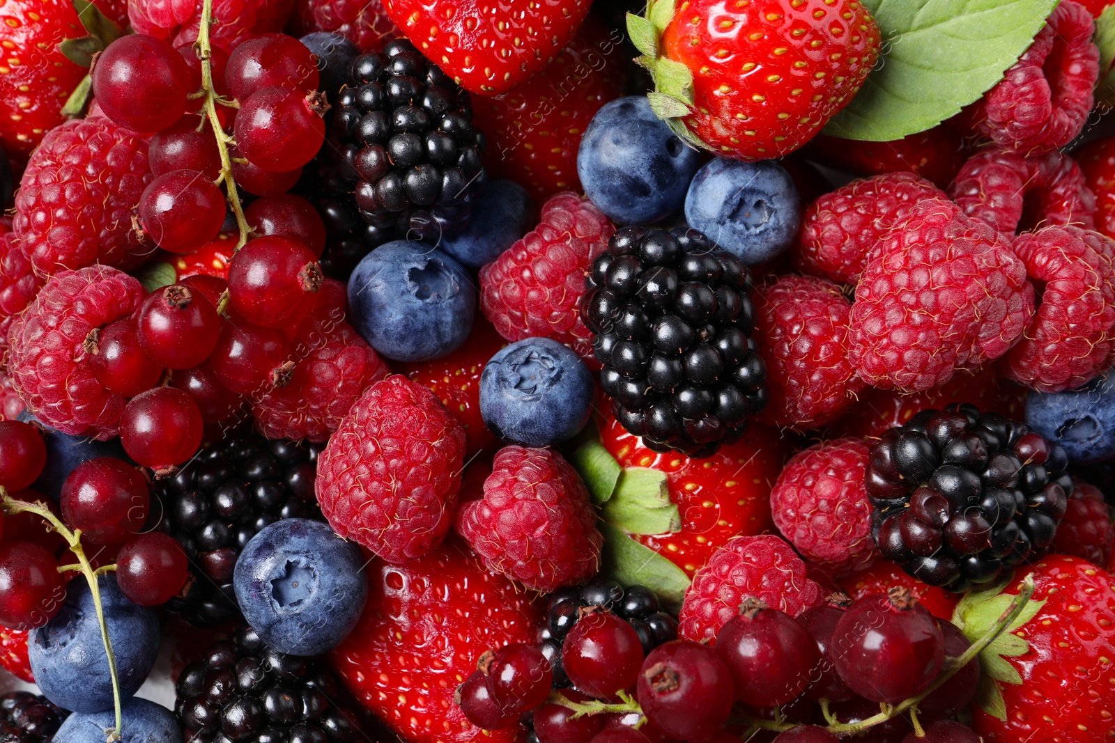 Photo of Different fresh ripe berries as background, top view