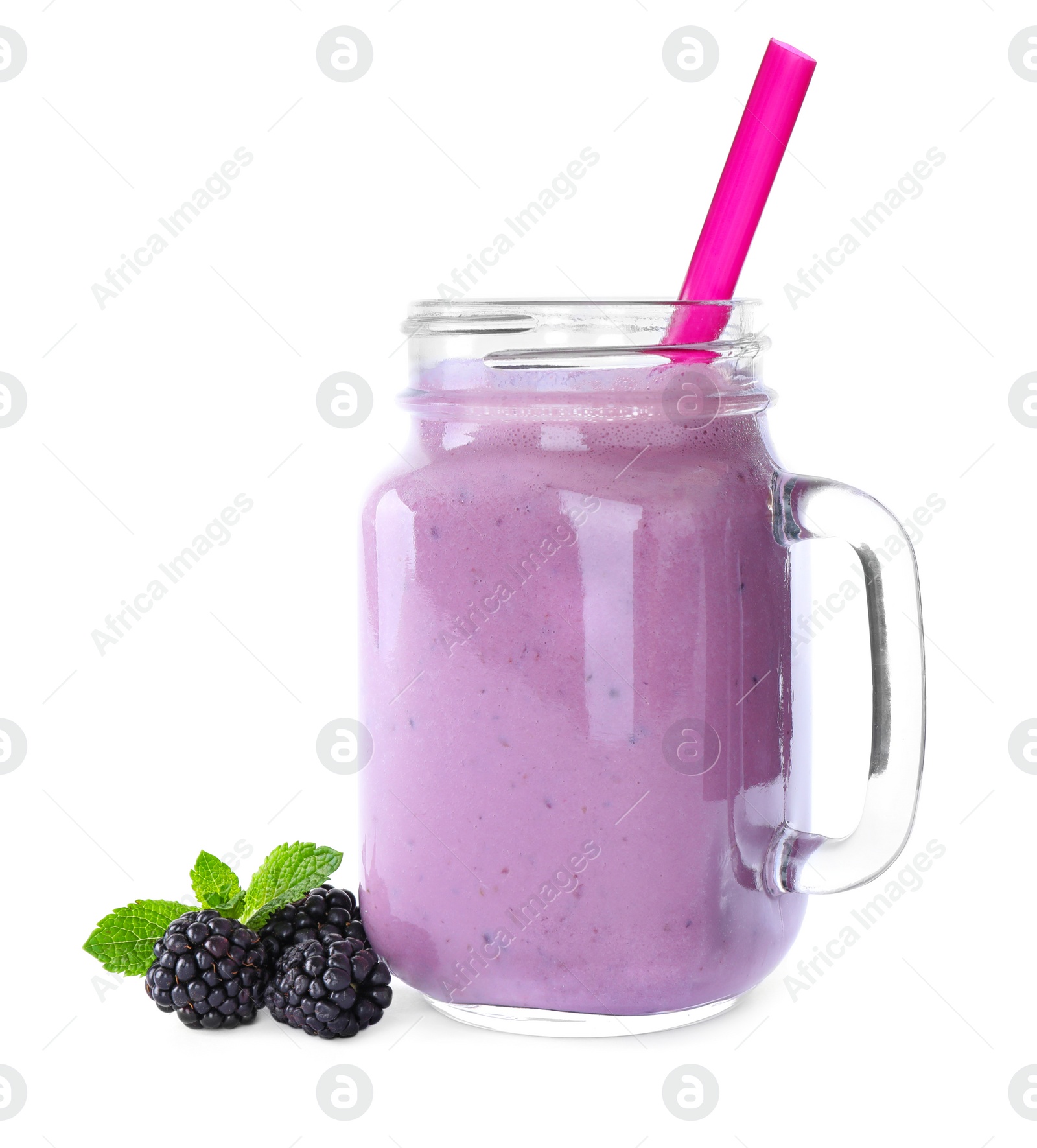 Photo of Tasty fresh milk shake in mason jar and blackberries on white background