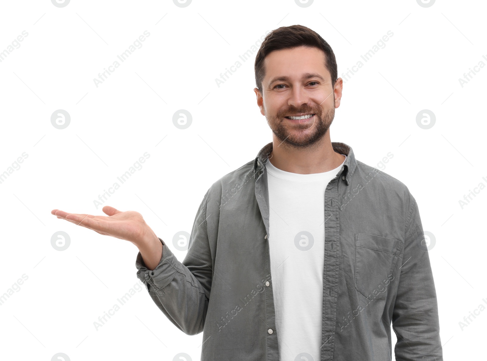 Photo of Special promotion. Smiling man holding something on white background