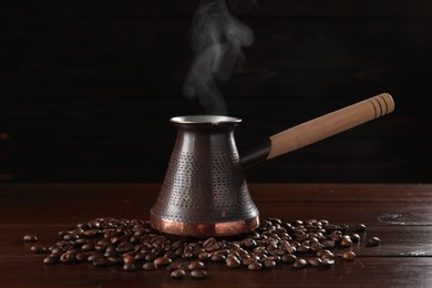 Photo of Turkish coffee in cezve and beans on wooden table