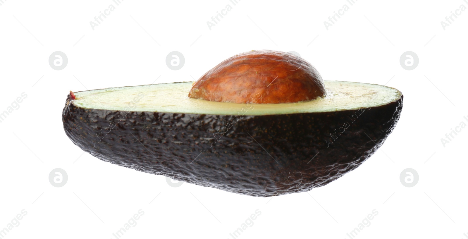 Photo of Half of ripe avocado with pit isolated on white