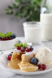Photo of Tasty vanilla fondant with white chocolate, berries and ice cream on white marble table, closeup. Space for text