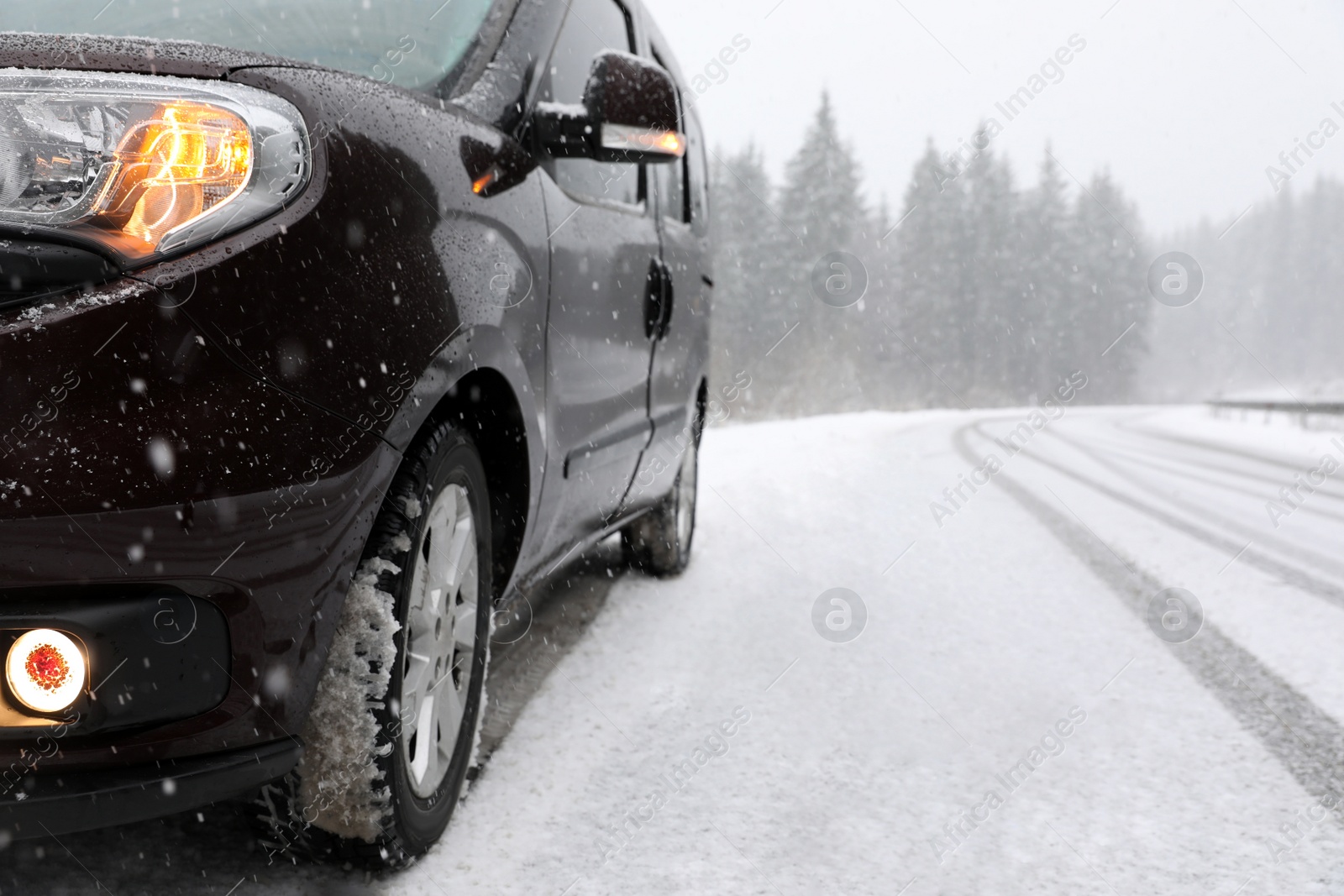 Photo of Country road with car on snowy winter day. Space for text