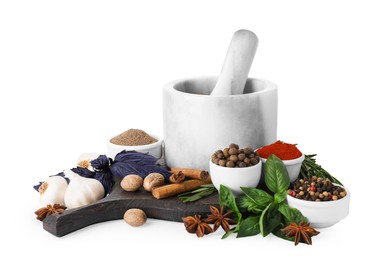 Photo of Mortar with pestle and different spices on white background