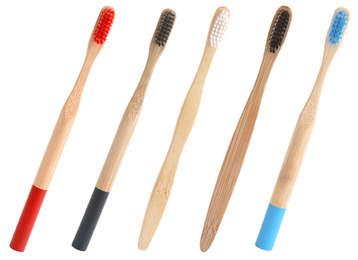 Image of Set of bamboo toothbrushes on white background 