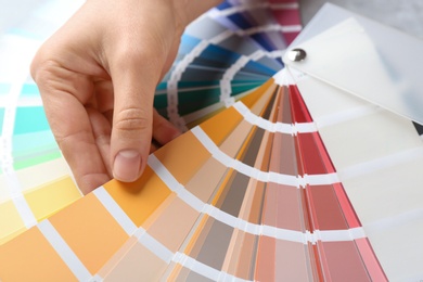 Photo of Young woman with color palette samples, closeup