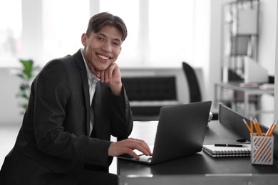 Man watching webinar at table in office