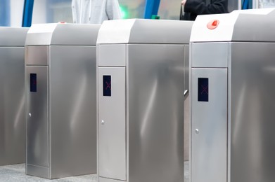 Photo of Many modern turnstiles, closeup view. Fare collection system