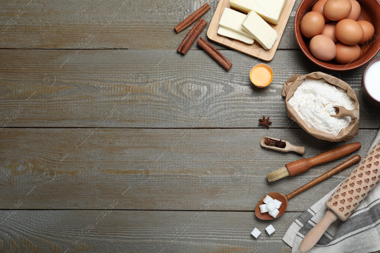 Photo of Cooking utensils and ingredients on wooden table, flat lay. Space for text