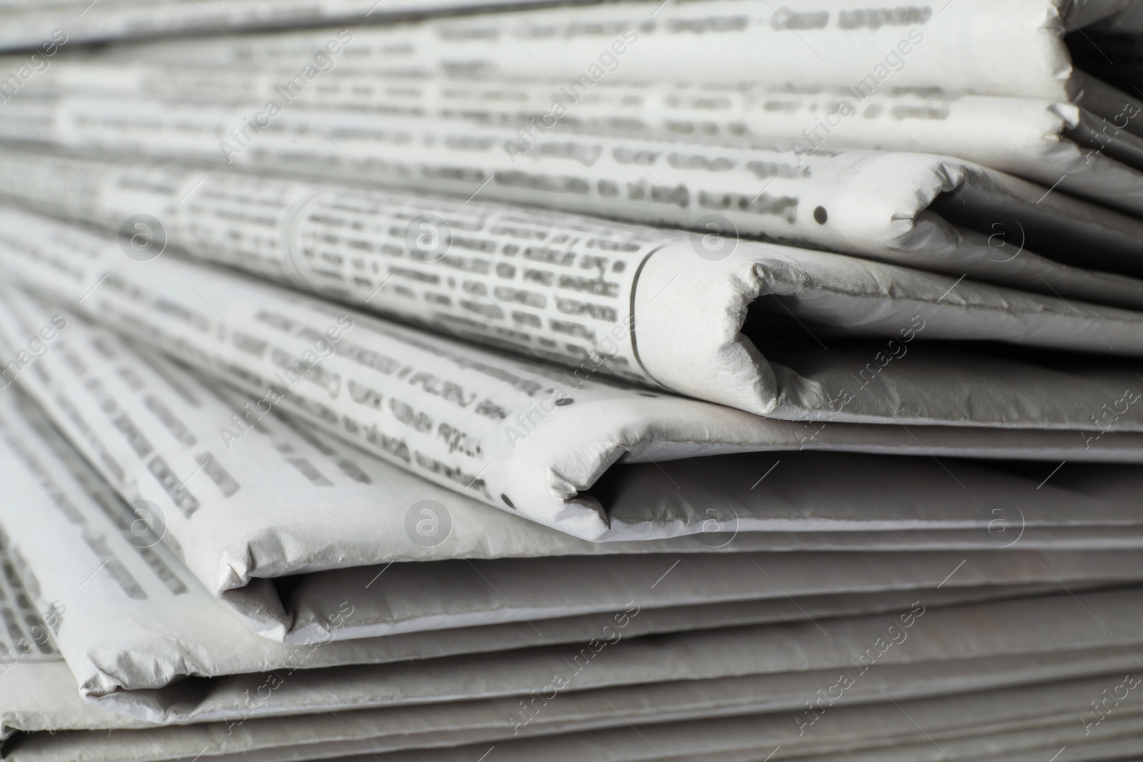 Photo of Stack of newspapers as background, closeup. Journalist's work