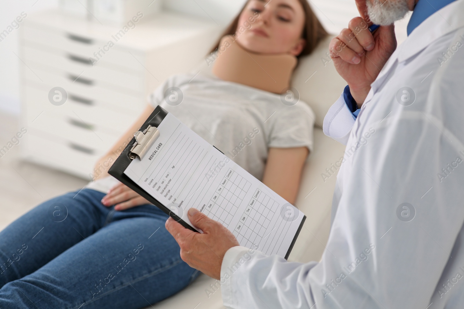 Photo of Doctor filling patient's medical card in clinic, closeup