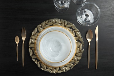 Photo of Elegant table setting on dark background, top view