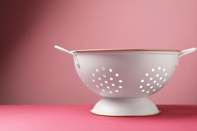 One clean empty colander on color background