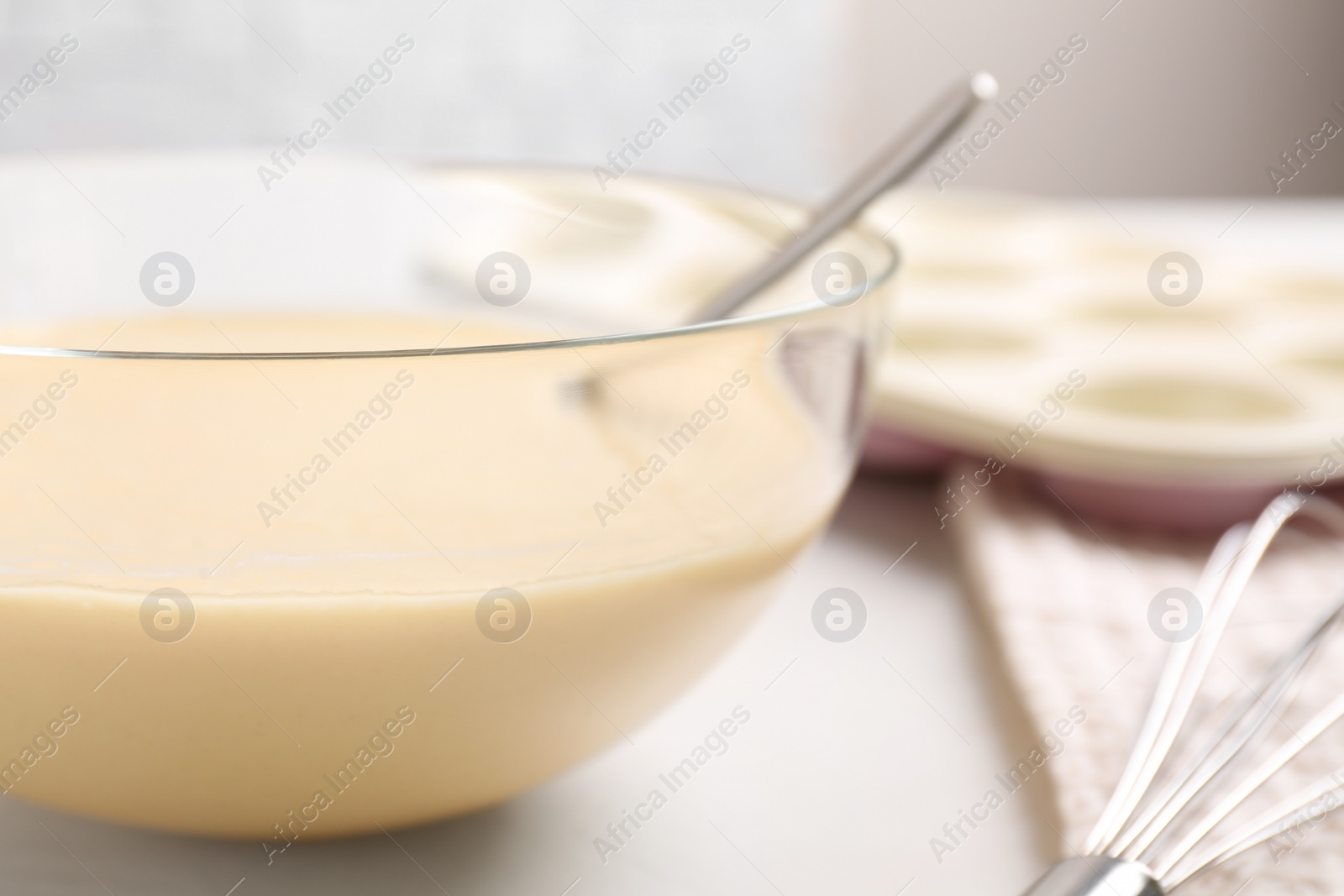 Photo of Glass bowl with batter on light table, closeup