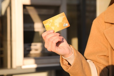 Photo of Woman with credit card near cash machine, closeup