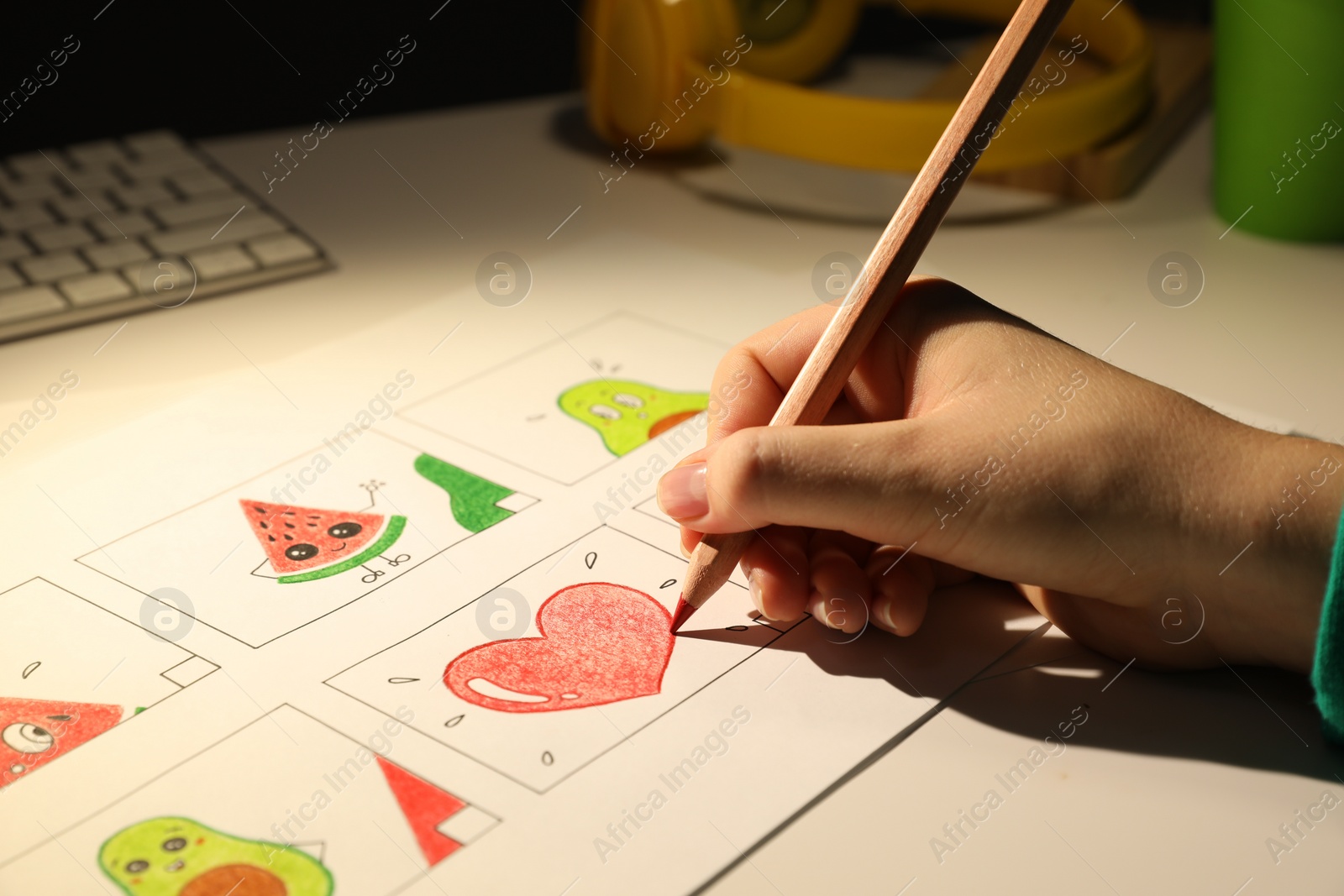 Photo of Woman drawing cartoon sketch at workplace, closeup. Pre-production process