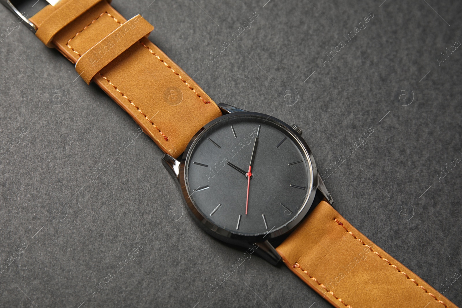 Photo of Stylish wrist watch on dark background. Fashion accessory