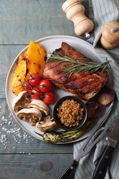 Photo of Delicious grilled meat and vegetables served on wooden table, flat lay