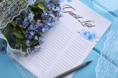 Guest list, pencil, lace ribbon and flowers on light blue wooden table, flat lay. Space for text