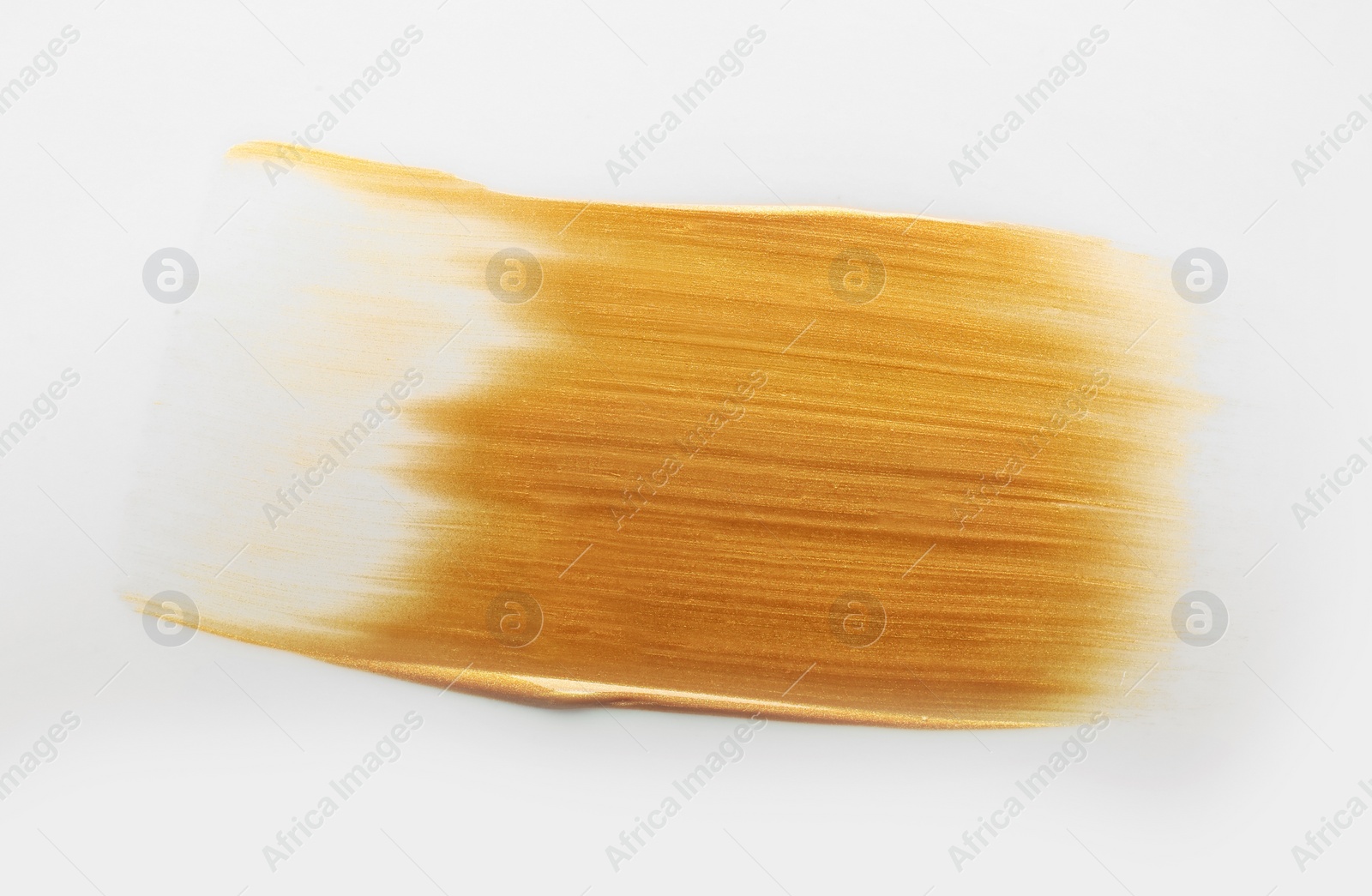 Photo of Stroke of gold paint isolated on white, top view