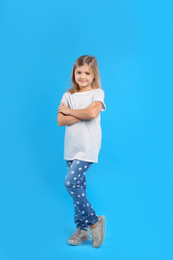 Cute little girl on light blue background