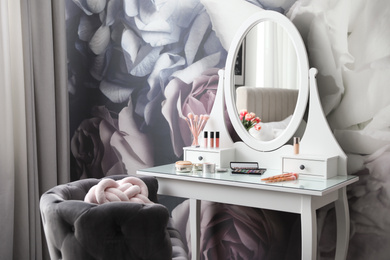 Photo of Stylish room interior with elegant dressing table and floral wallpaper