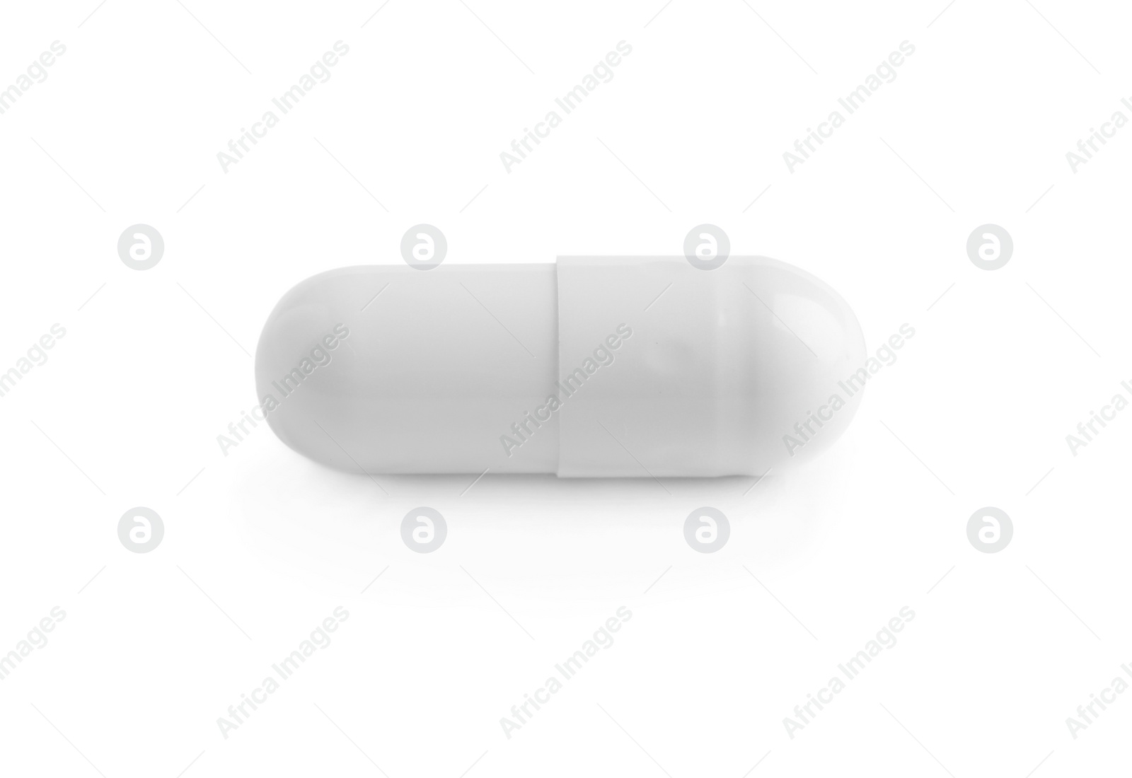 Photo of One pill on white background. Medicinal treatment