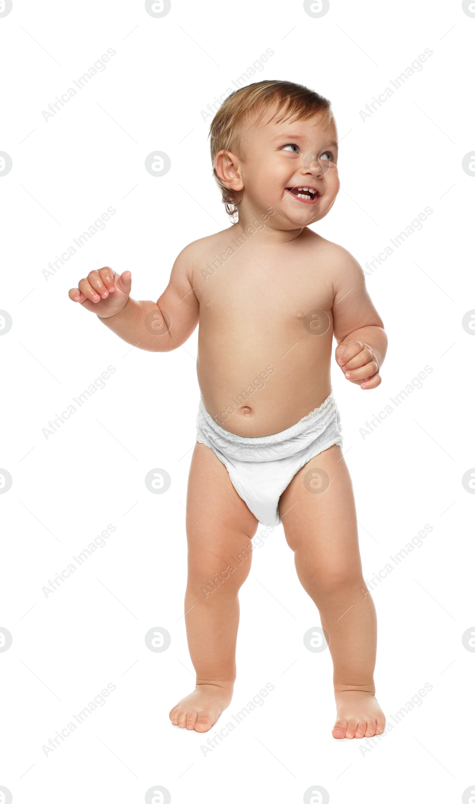 Photo of Cute baby in diaper learning to walk on white background