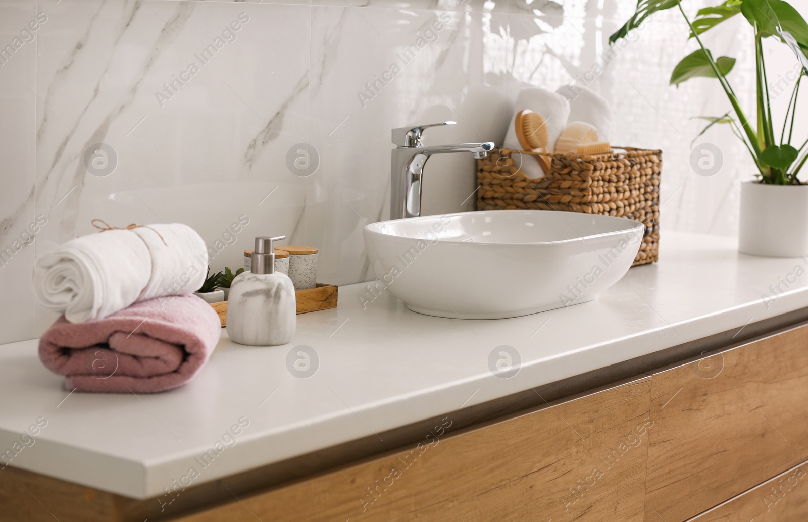 Photo of Stylish vessel sink on light countertop in modern bathroom