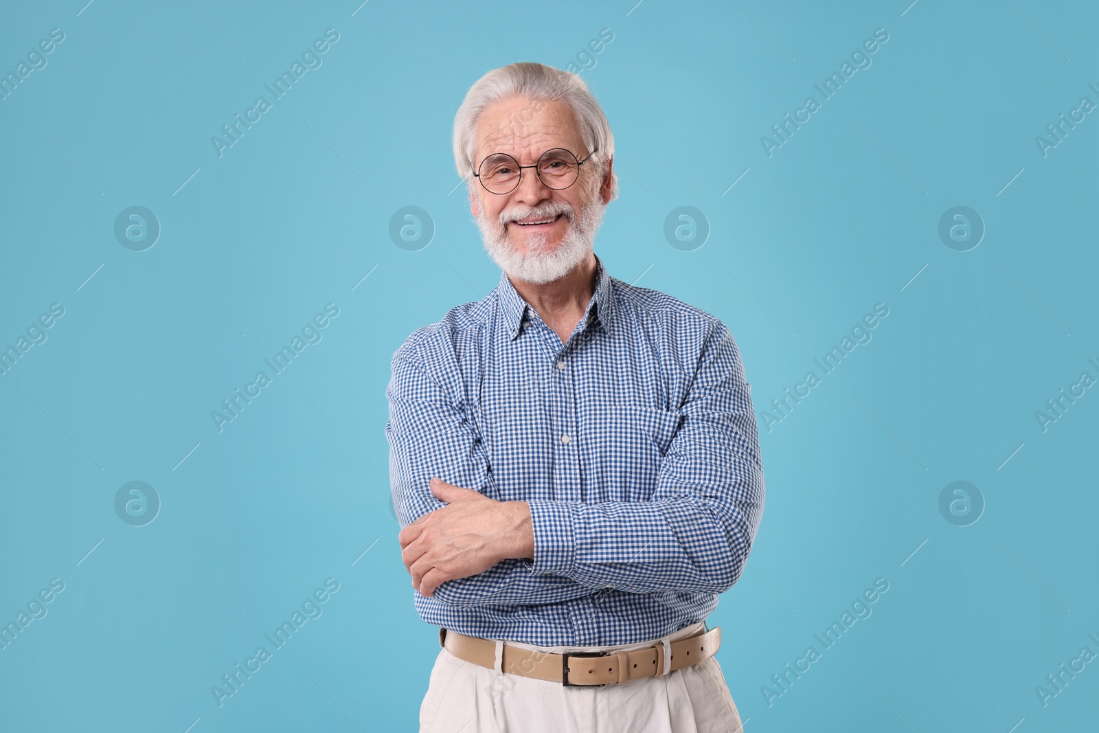 Photo of Portrait of stylish grandpa with glasses on light blue background