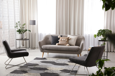 Photo of Modern living room interior with comfortable sofa and armchairs