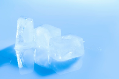 Photo of Ice cubes on color background. Space for text