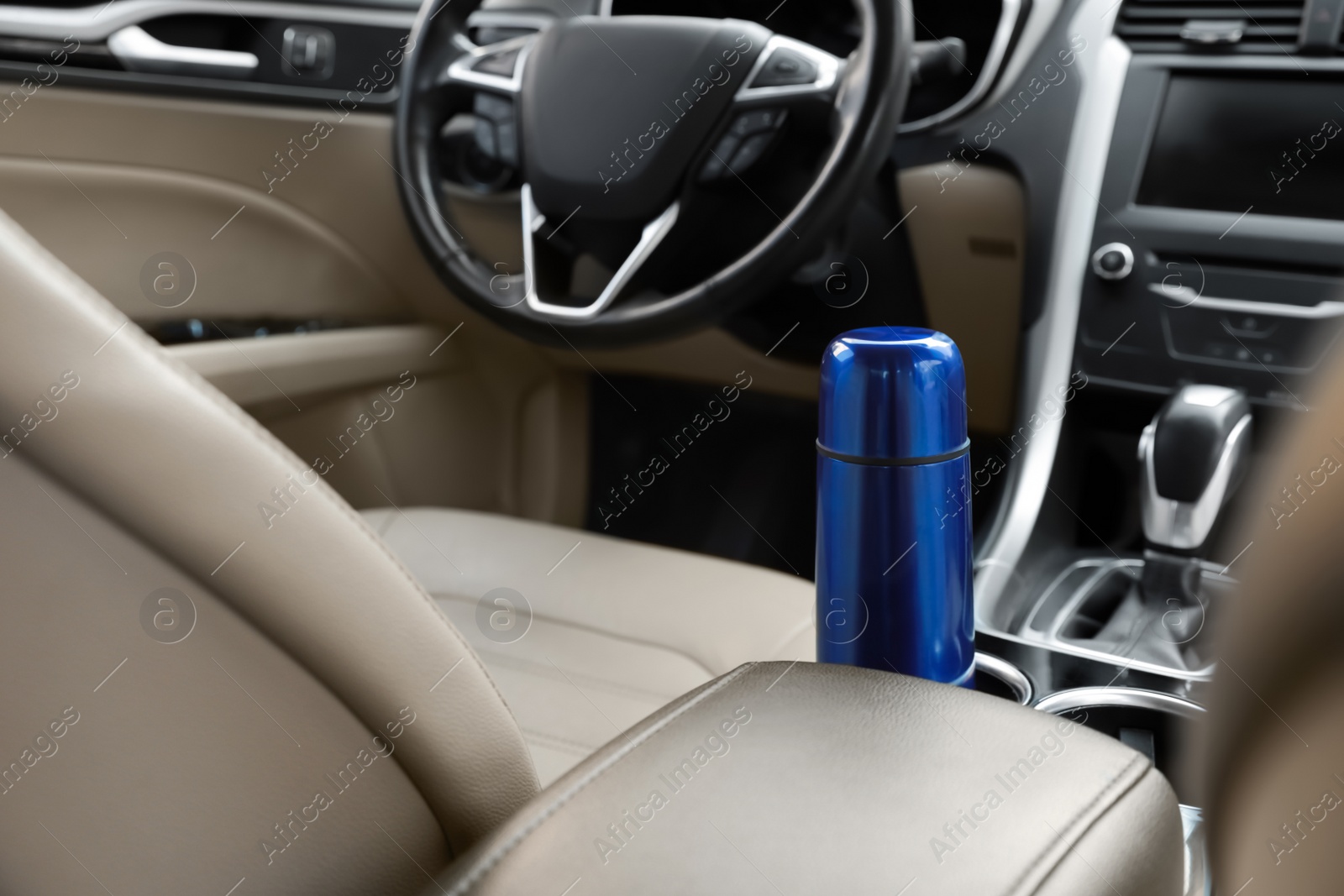 Photo of Blue thermos in holder inside of car
