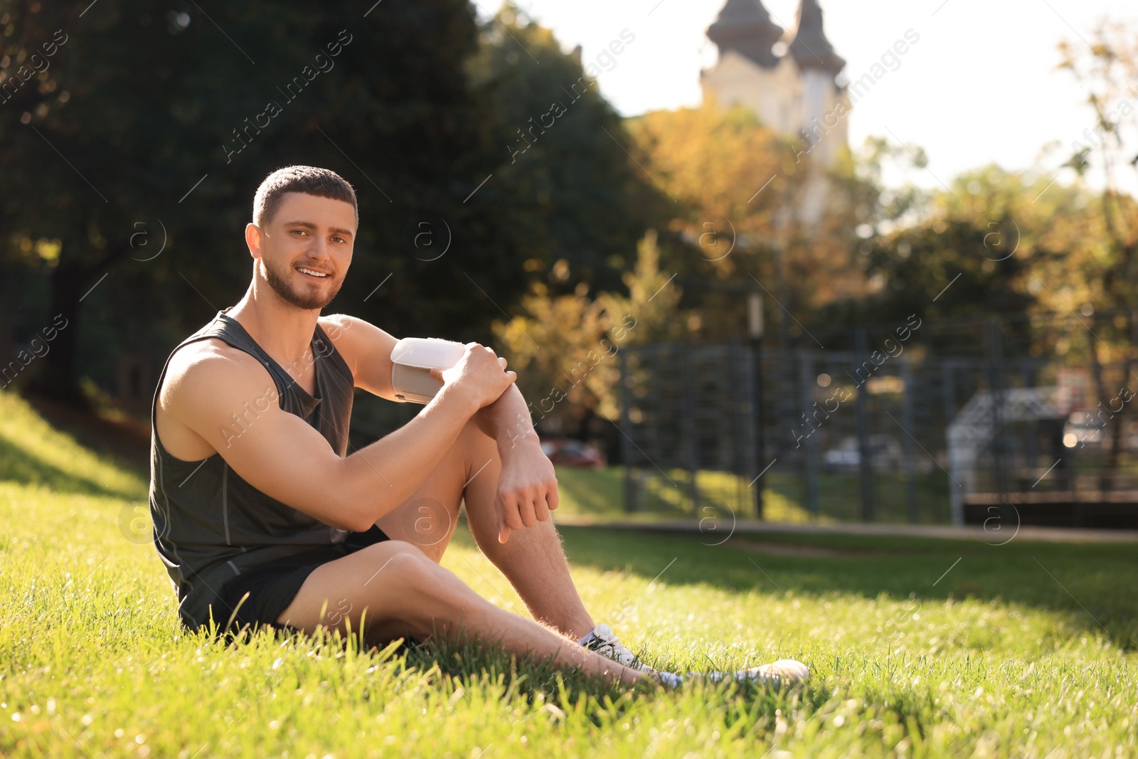 Photo of Man checking blood pressure with modern monitor after training in park. Space for text