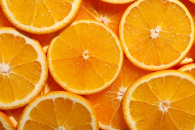 Photo of Slices of juicy orange as background, top view