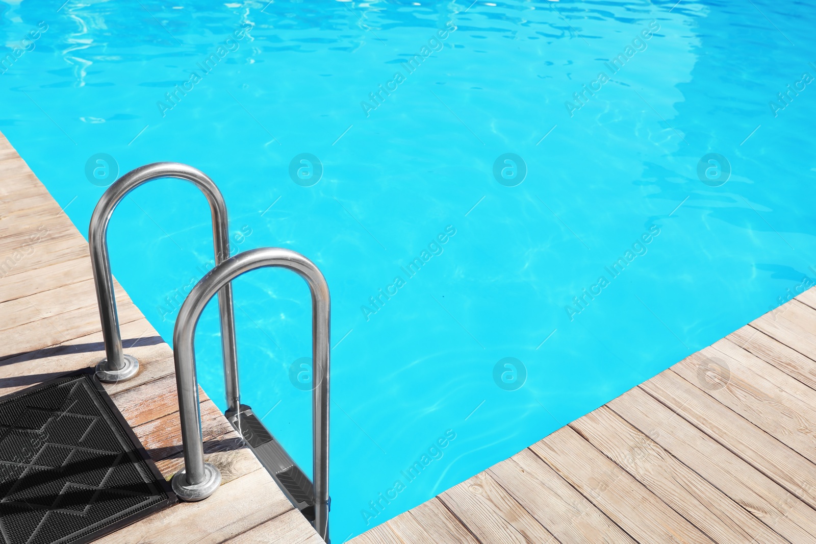 Photo of Modern swimming pool with step ladder outdoors