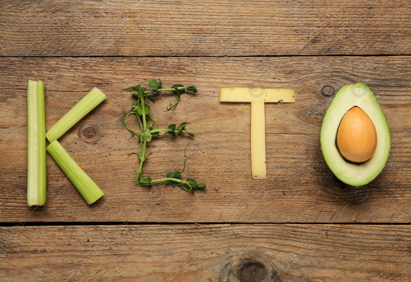 Photo of Word Keto made with different products on wooden table, flat lay