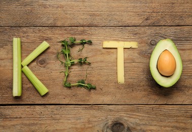 Word Keto made with different products on wooden table, flat lay