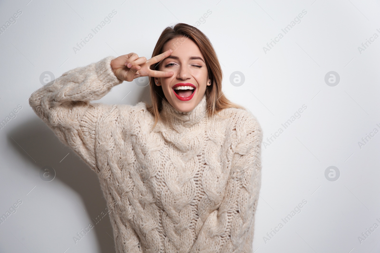 Photo of Beautiful young woman in warm sweater on white background