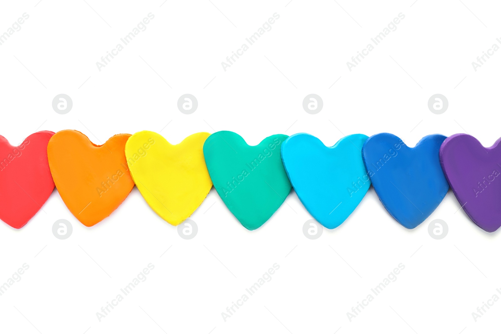 Photo of Colorful hearts made of modeling clay on white background, top view. Rainbow palette