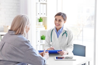 Photo of Female doctor consulting patient in clinic