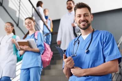 Photo of Portrait of medical student with clipboard on staircase in college, space for text