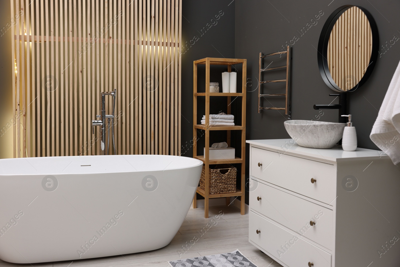 Photo of Stylish bathroom interior with heated towel rail and modern furniture