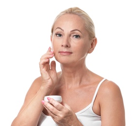 Portrait of beautiful mature woman with perfect skin holding jar of cream on white background